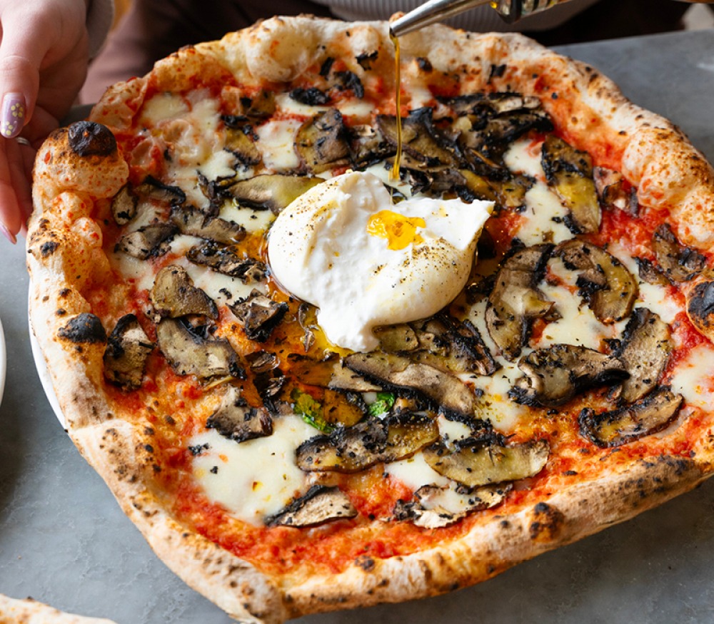 pizza topped with mushroom and poached egg