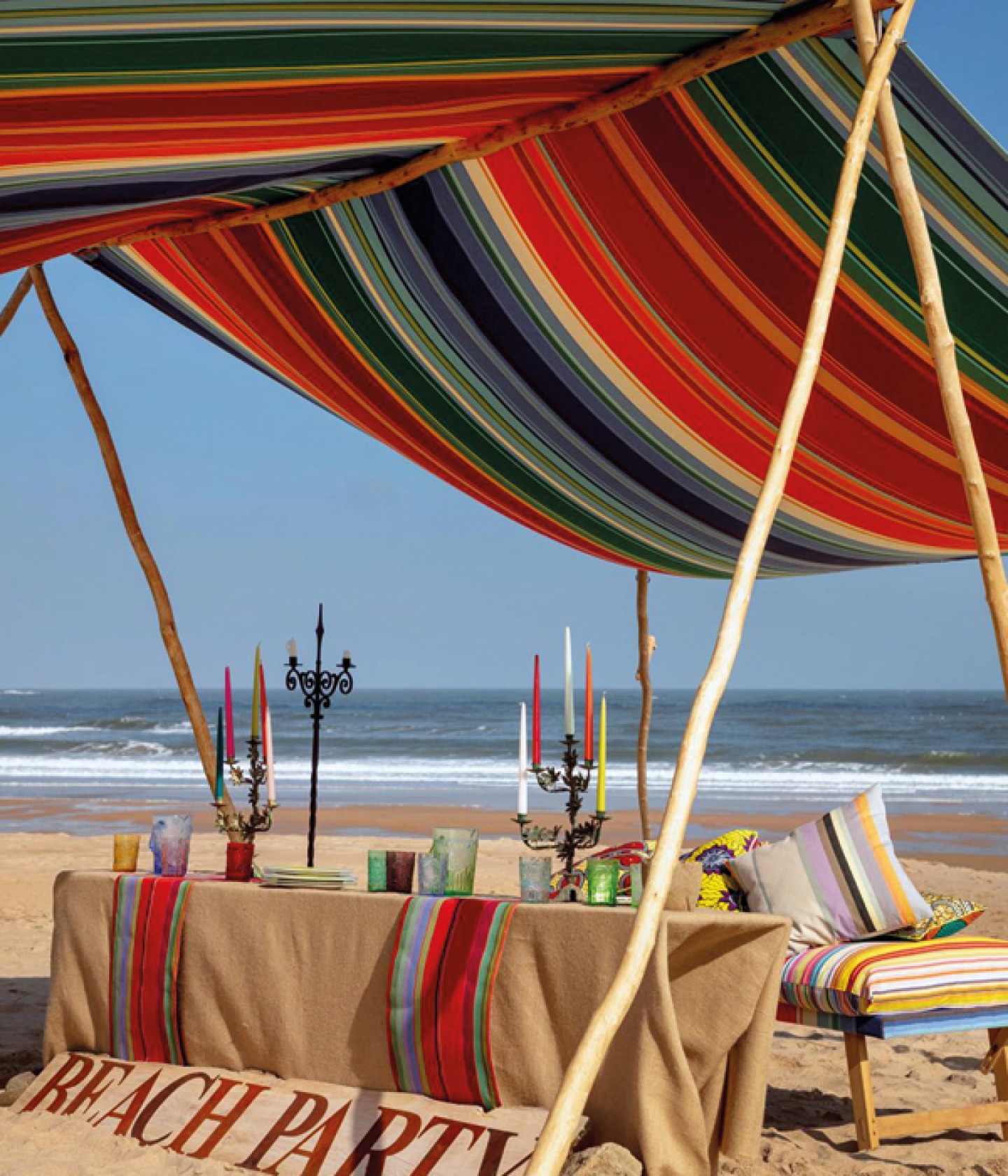 French Stripe wide fabric pulled over a bamboo frame to create a tent to cover a make shift table with candelabra