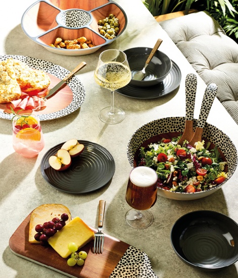 Lifestyle picture of an outdoor table set with drinks food and crockery