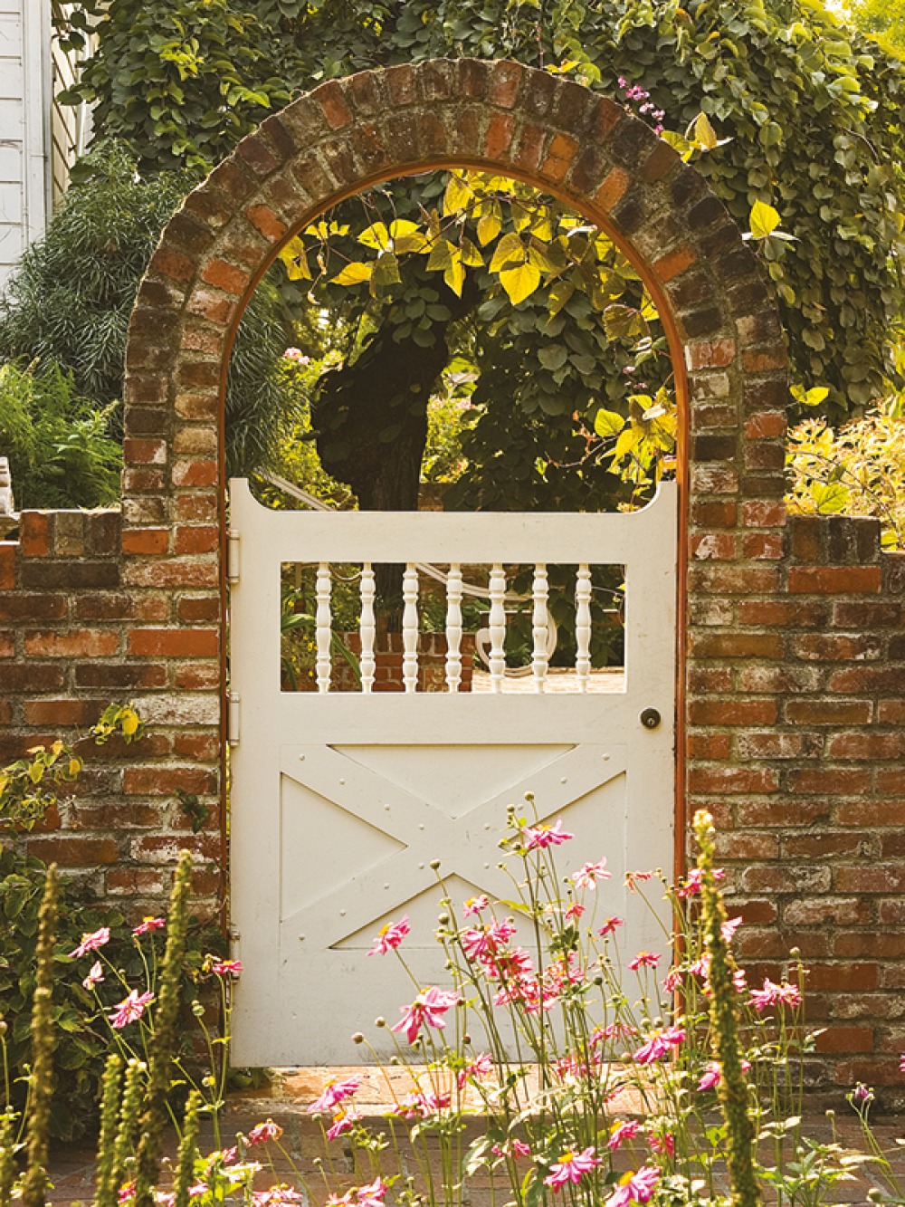Cream garden gate with brick arch over the top