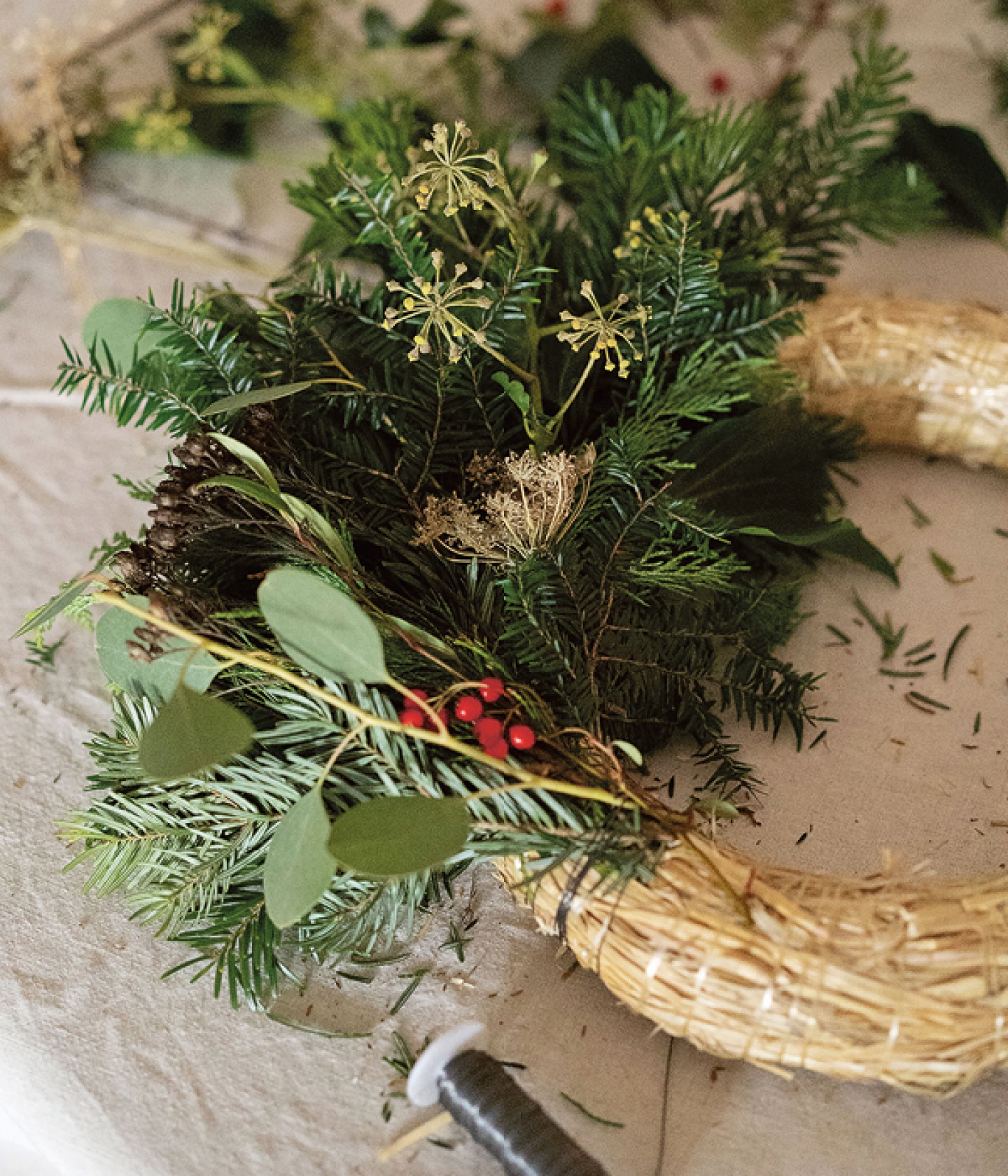 section of a wreath hoop decorated with foliage