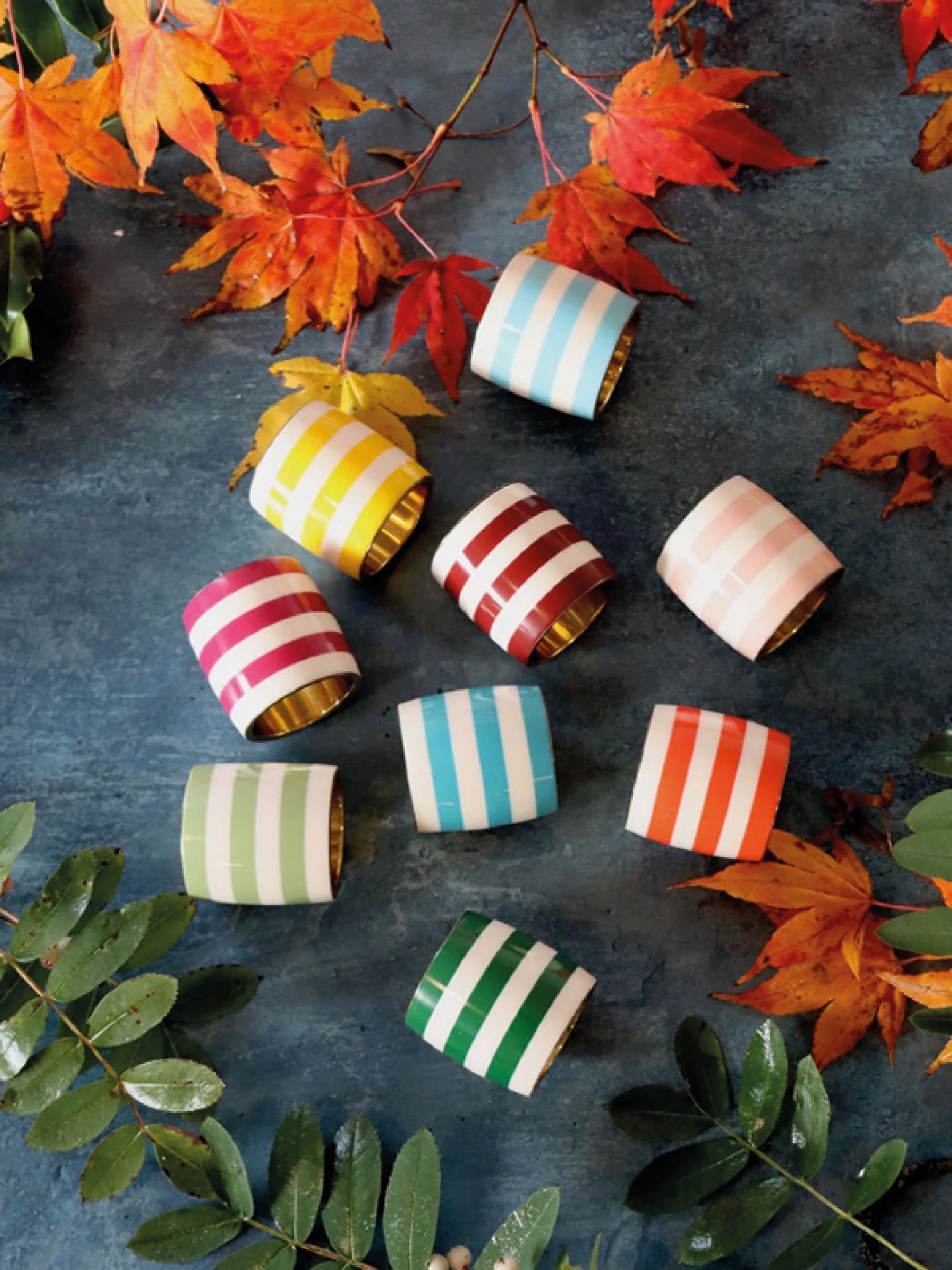 Brightly coloured striped brass napkin rings
