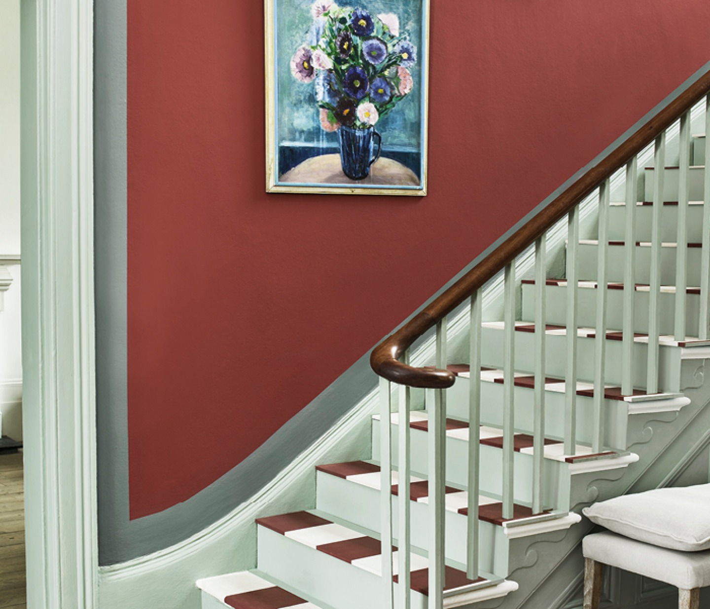 painted red staircase wall with matching colours in stairs