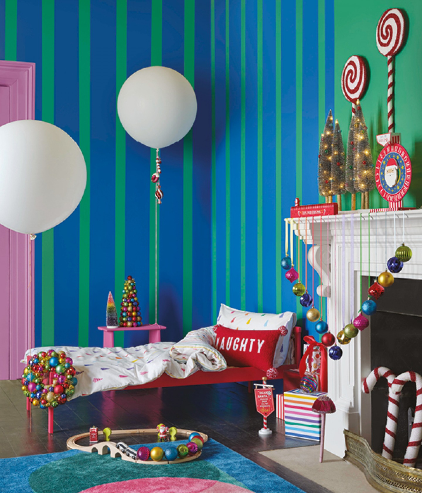 Brightly coloured bedroom with balloons, colourful; baubles and candy lollipop wall decorations