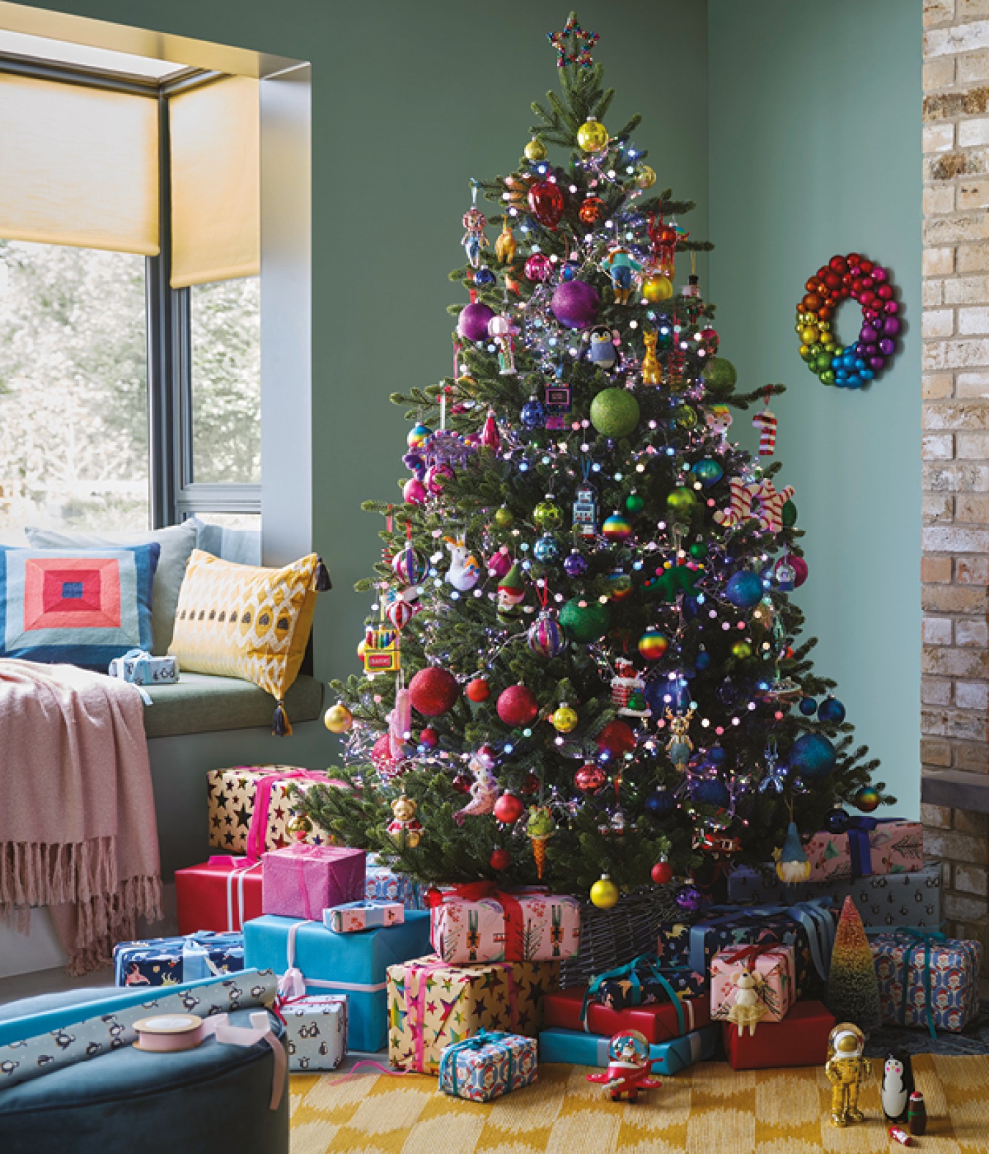 colourful themed Christmas tree with wrapped presents underneath