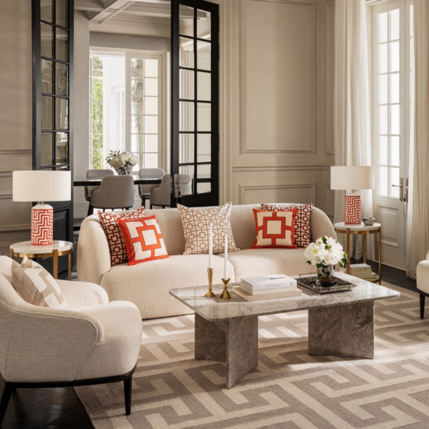 modern living room decorated with muted colours and pops of orange furnishings