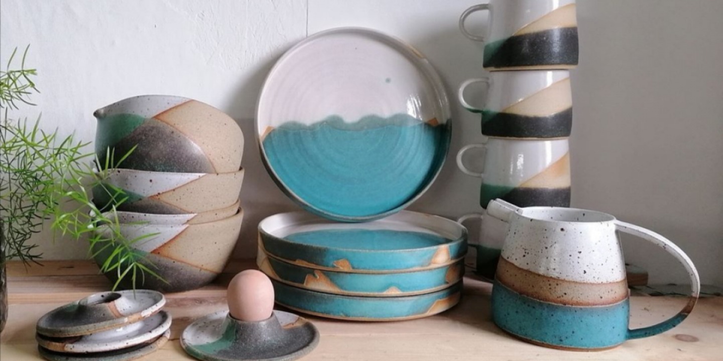 collection of finished pottery including cups, bowls and plates