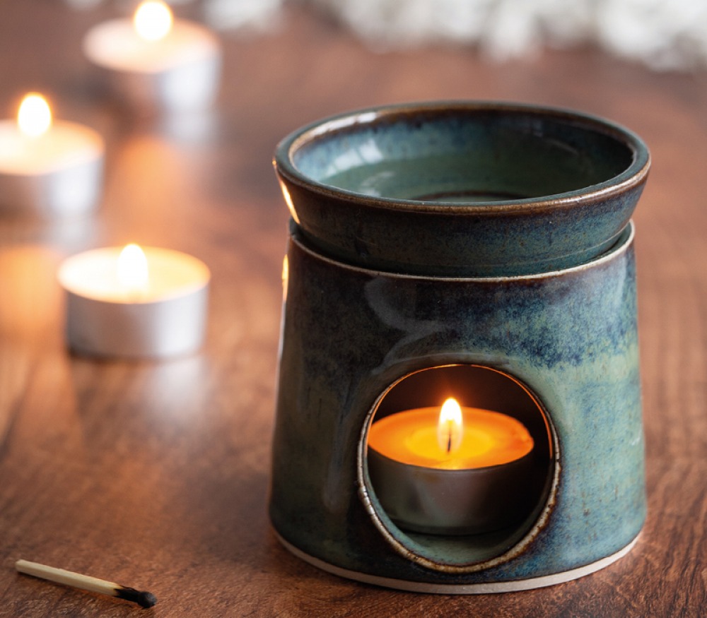 blue and sea green wax melt burner with a light tea light