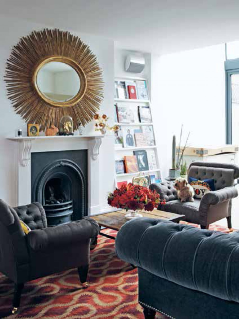 living room with fireplace, feature mirror and bookshelf 