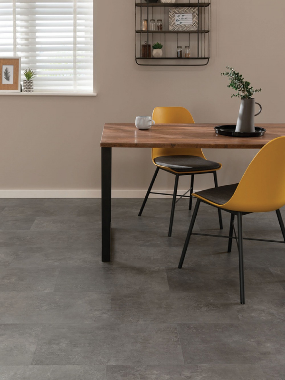 grey flooring, dining table with 2 yellow chairs