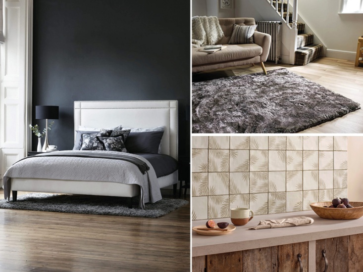 white bed dressed in navy blue, grey rug, and kitchen work bench with figs and a mug