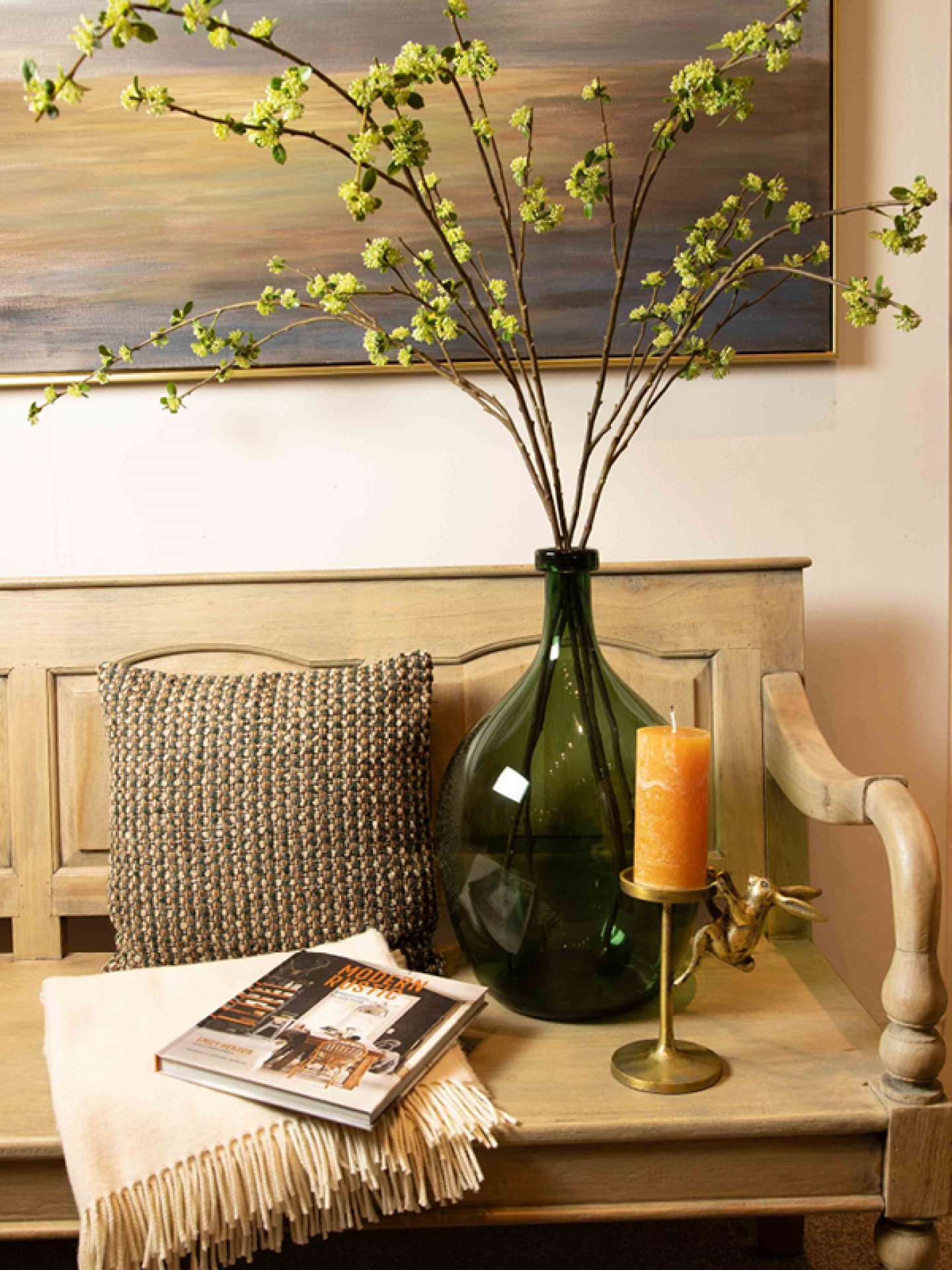 Lighter Tones and Soft, Layered Textures, candle, throw, pillow and vase styled on a wooden bench