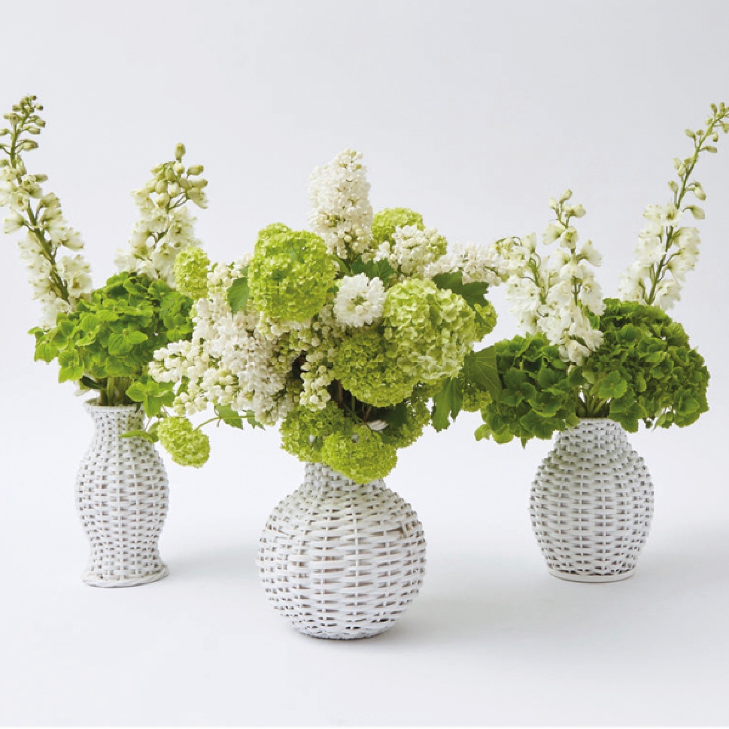 white wicker vases with flowers in