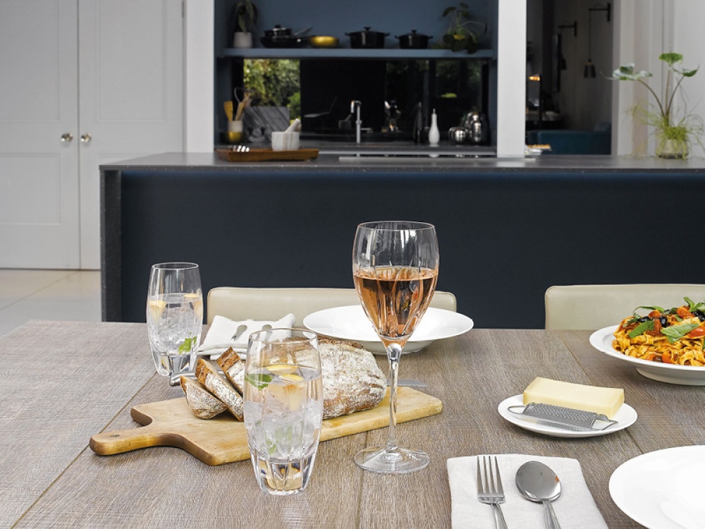 glasses on a table with bread and pasta