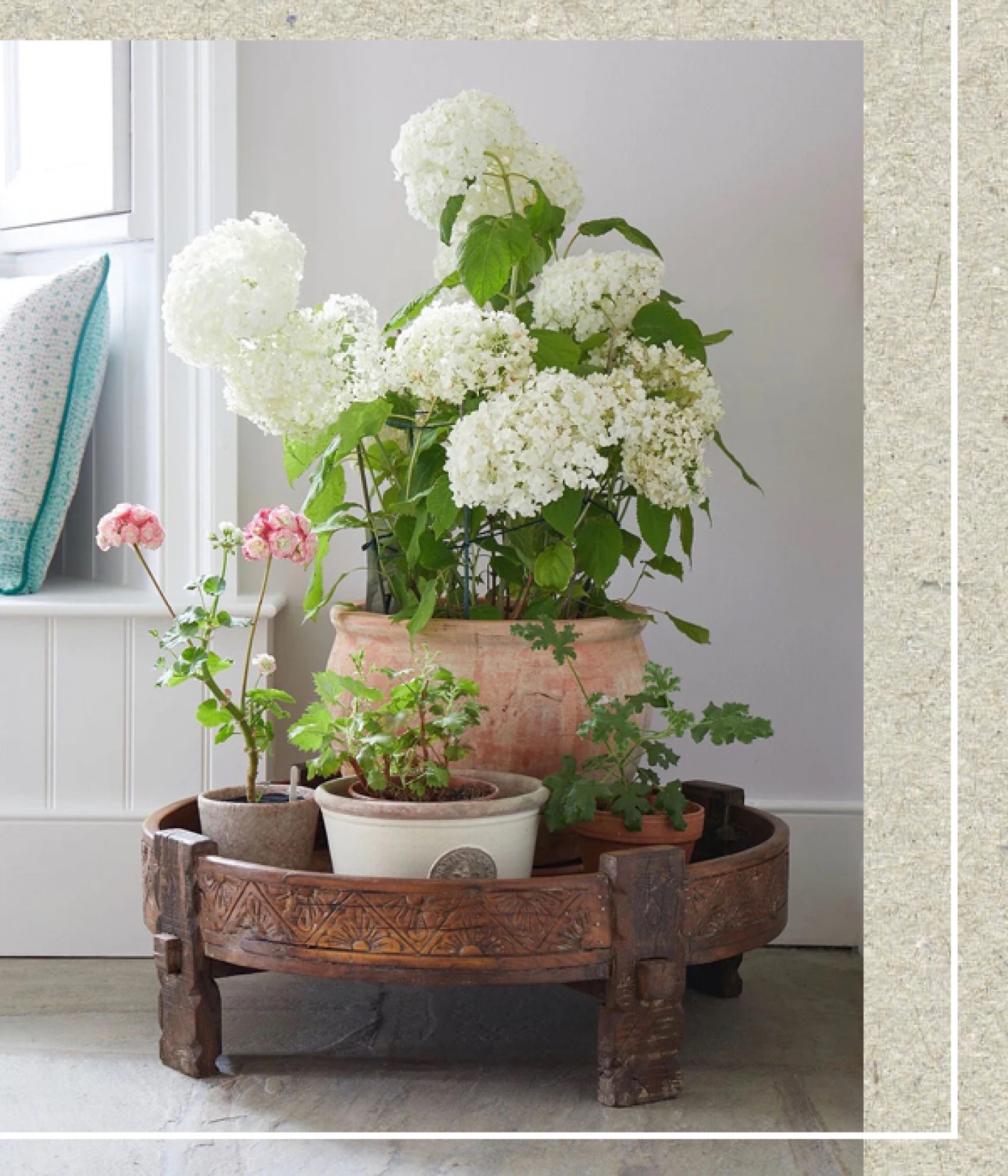potted flowers on a flower stand made from wood