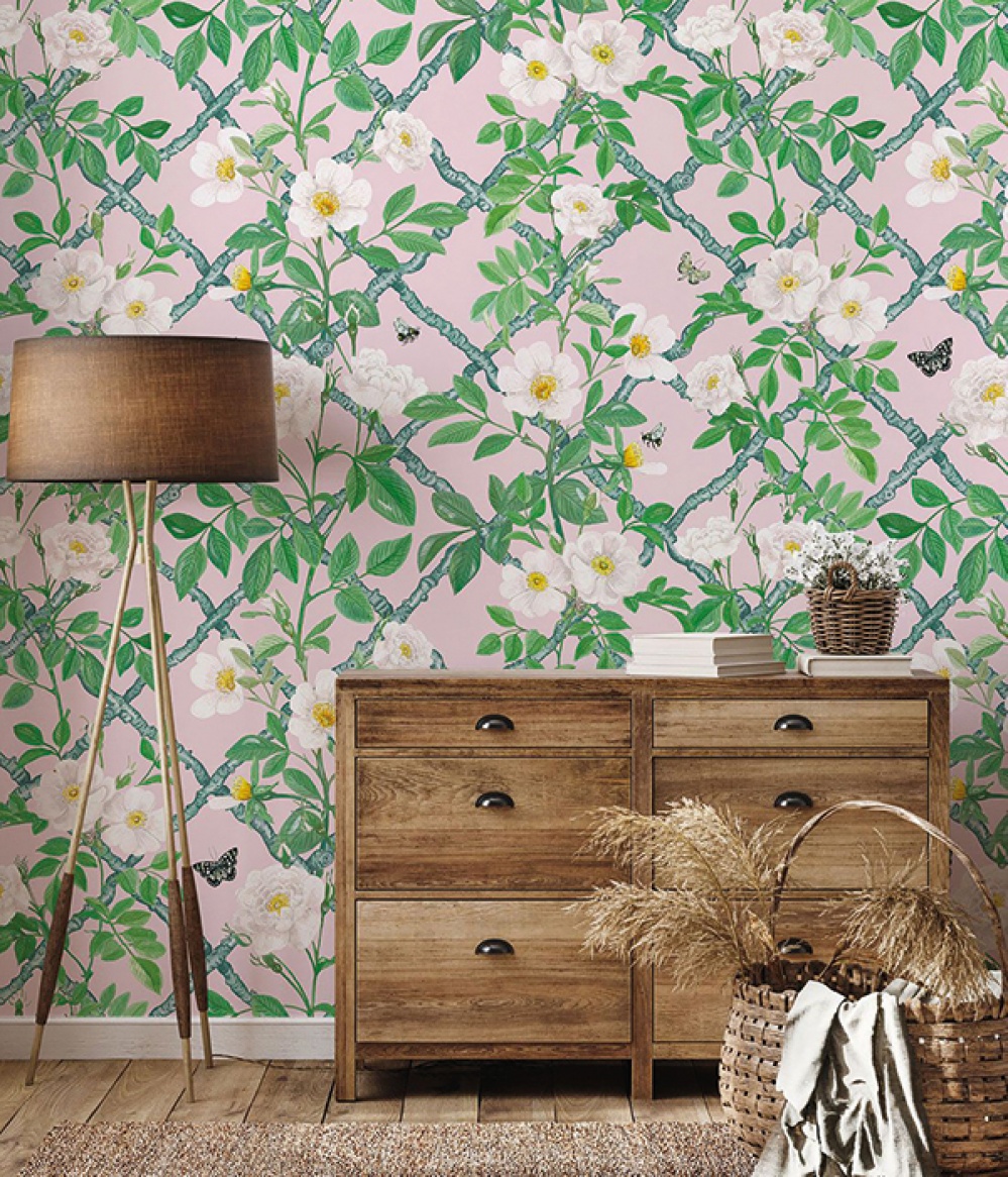 Bright floral and lattice wallpaper with a lamp and dresser in the foreground