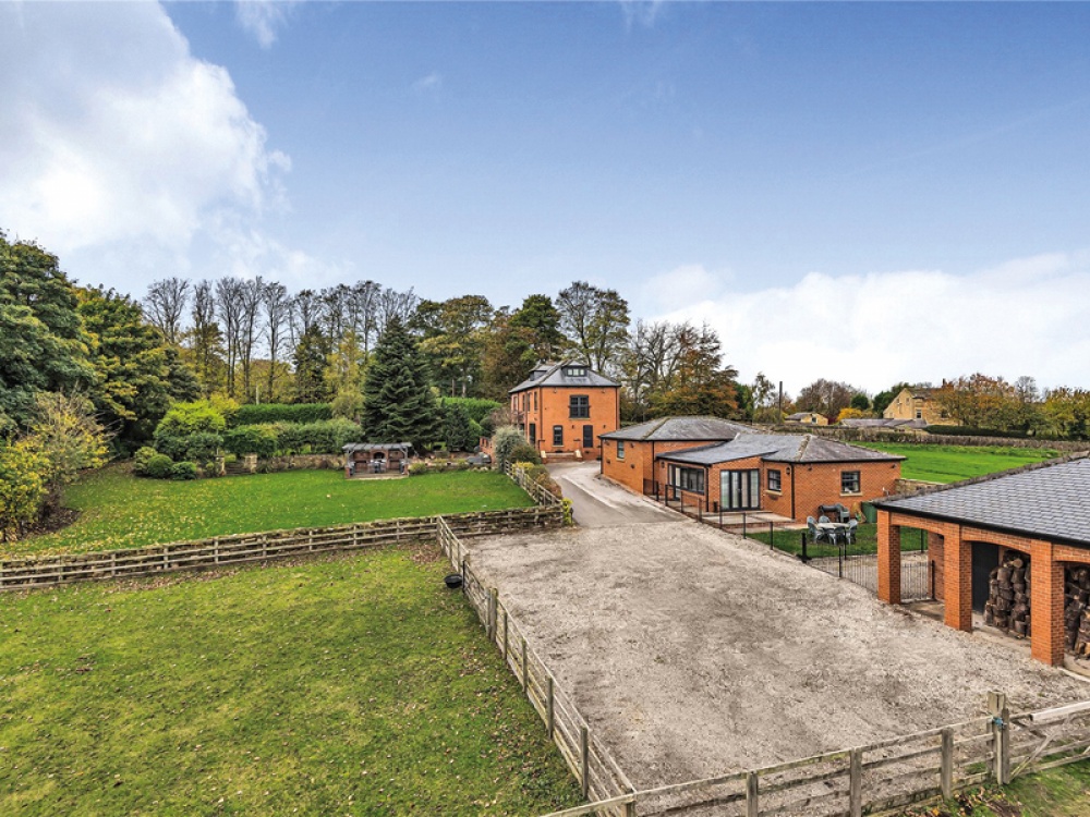 red brick farm house with outbuildings