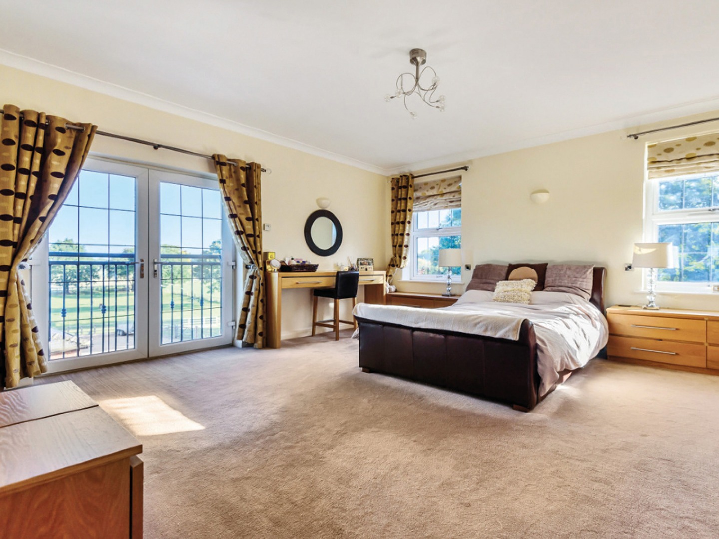 large bedroom with a double bed and a Juliet balcony