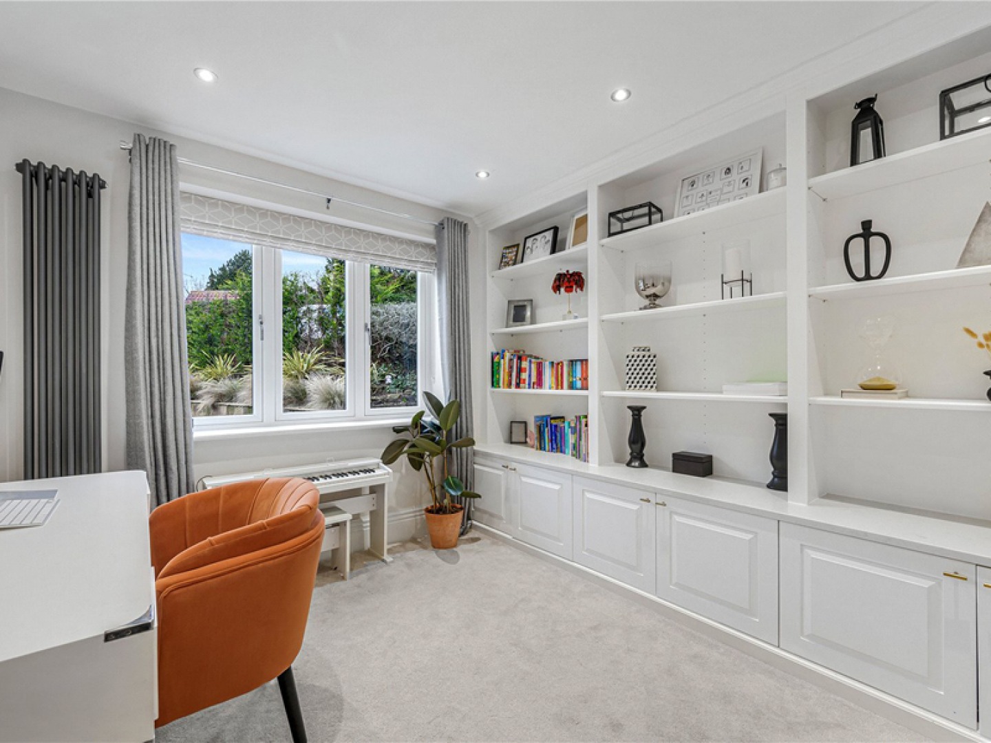 white home office with an orange leather chair