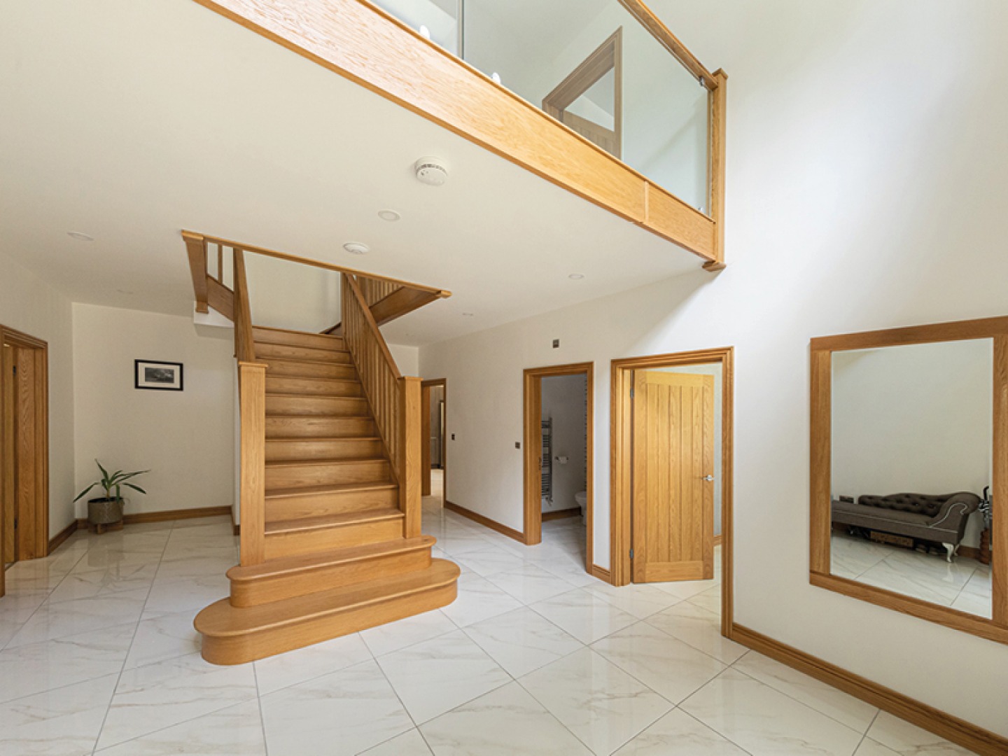 large entrance room with staircase and mezzanine landing
