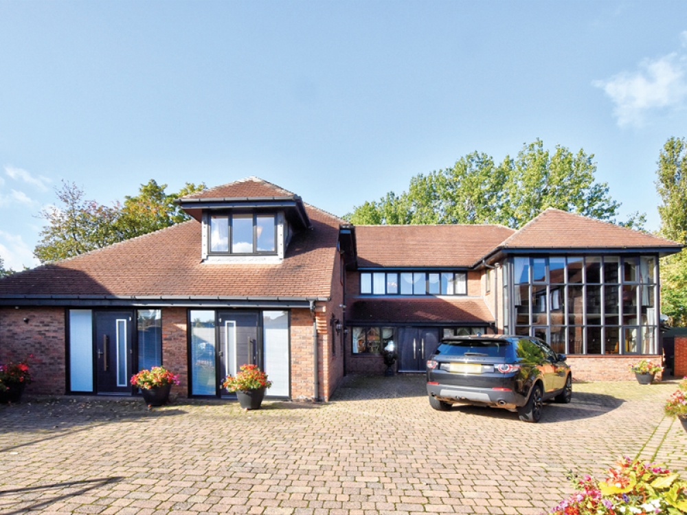 a detached house with a car parked out front