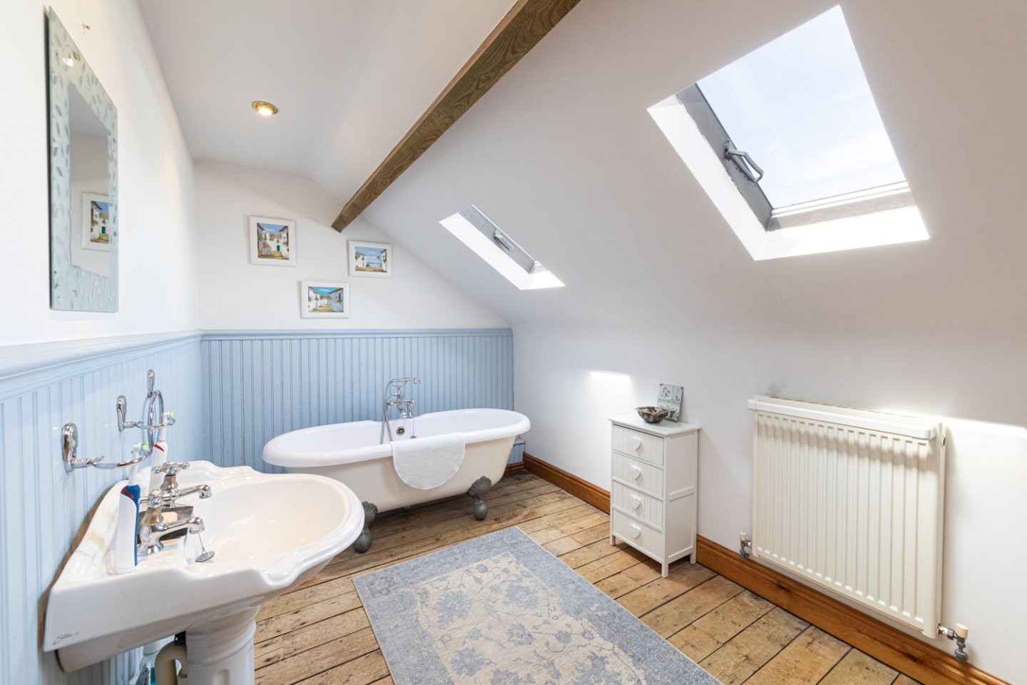 modern bathroom with freestanding bath and blue panelling
