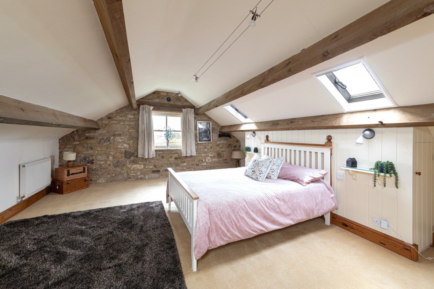 Double bedroom with exposed stone and beams