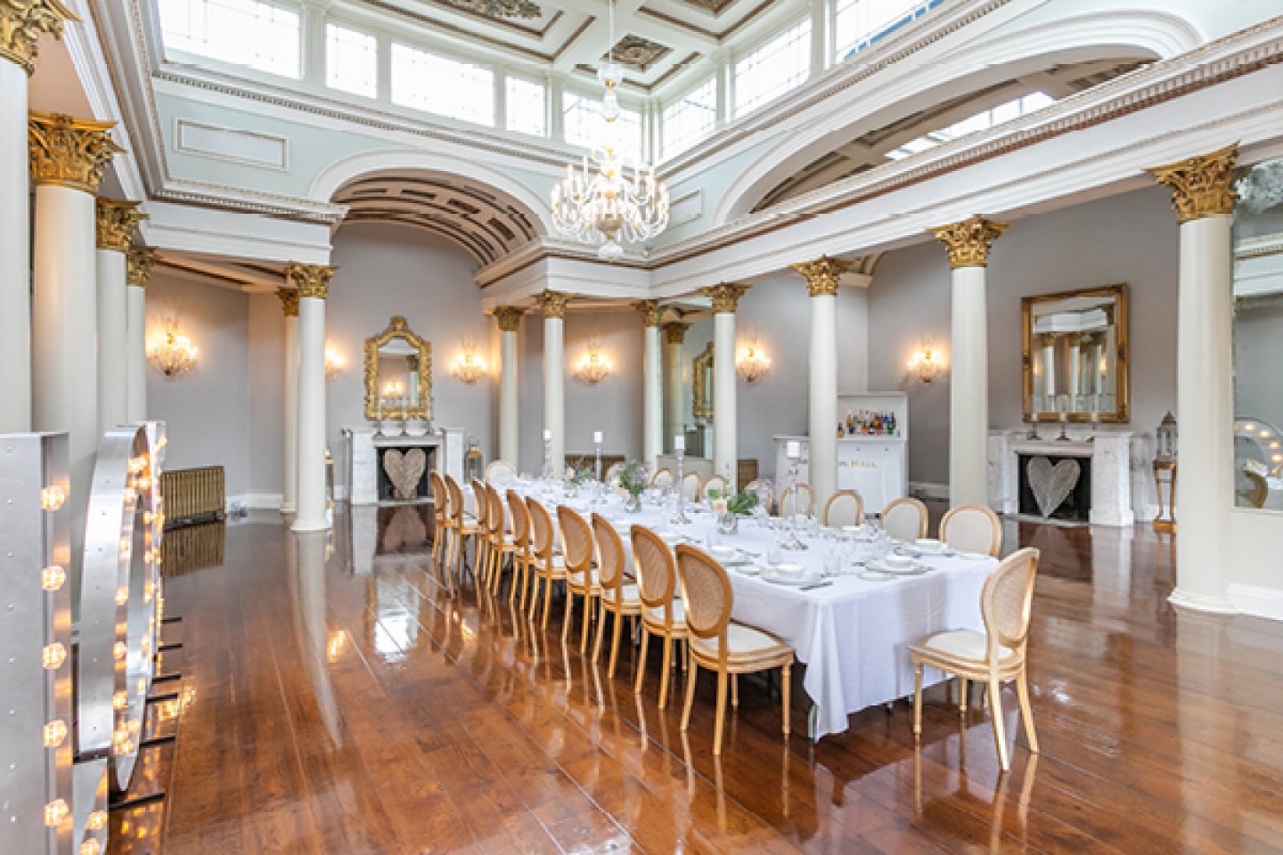Large, formal, decadent white and gold dining room