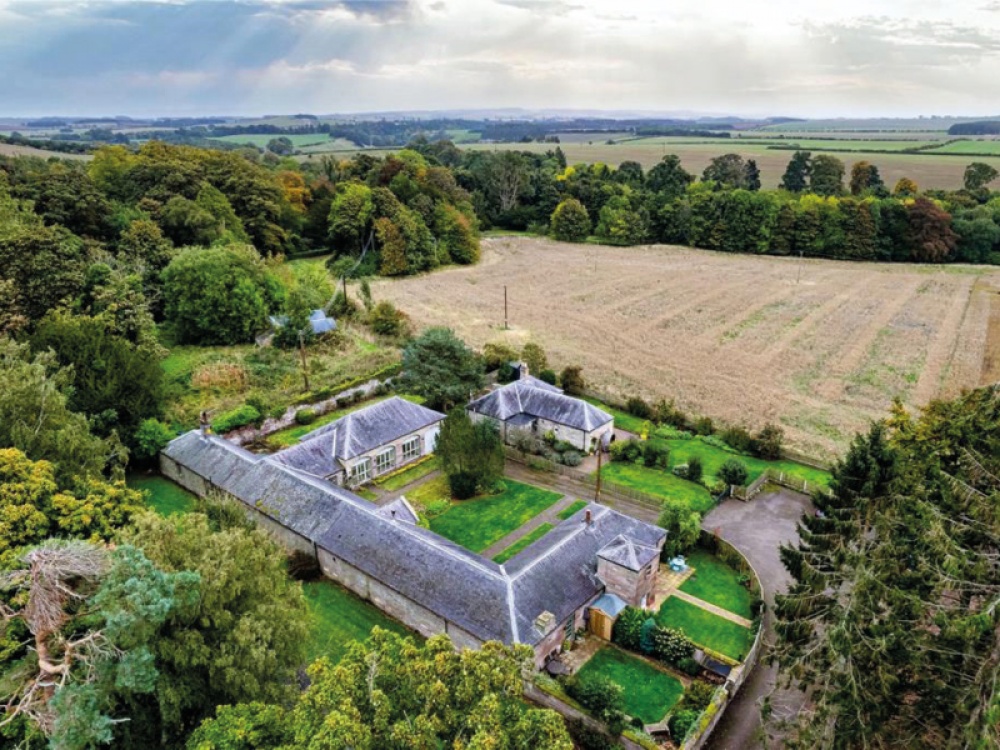 drone shot of a bungalow in the countryside