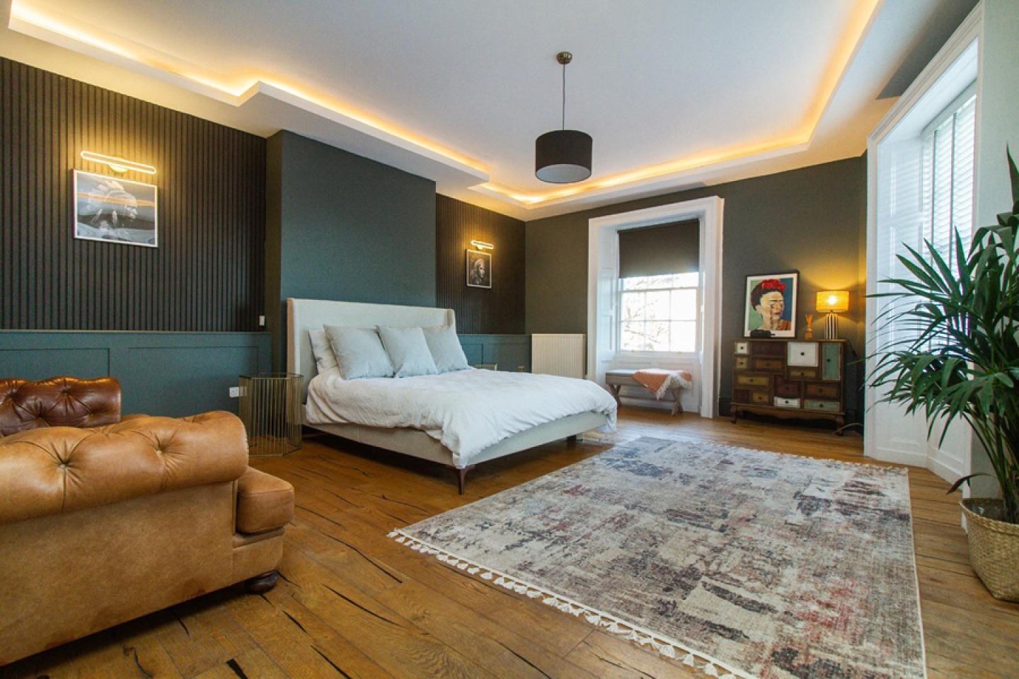 Large Modern master bedroom, forrest green walls, paneling, mood light, feature windows and wooden flooring