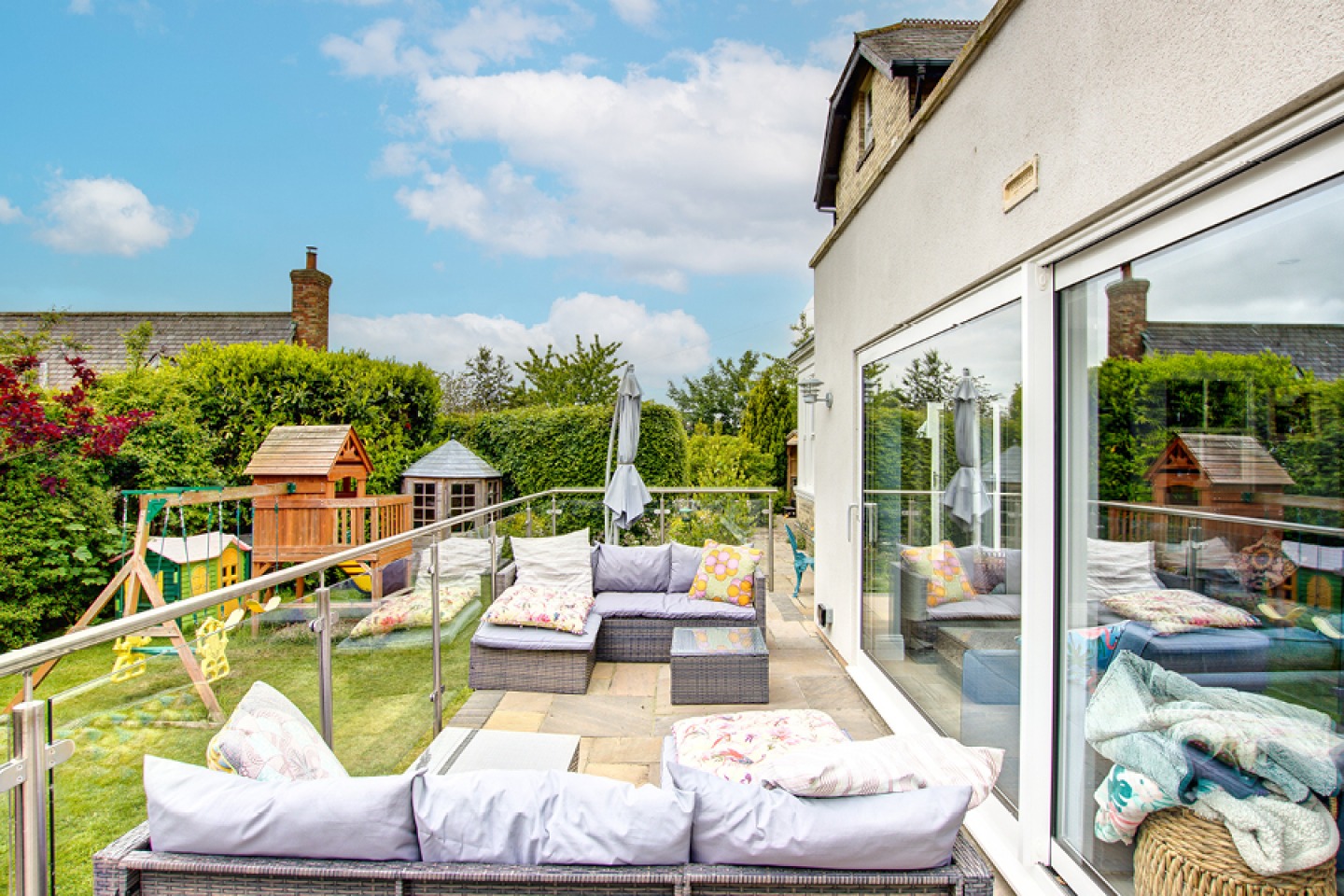 Modern sitting area on a garden terrace with view of Childs play area