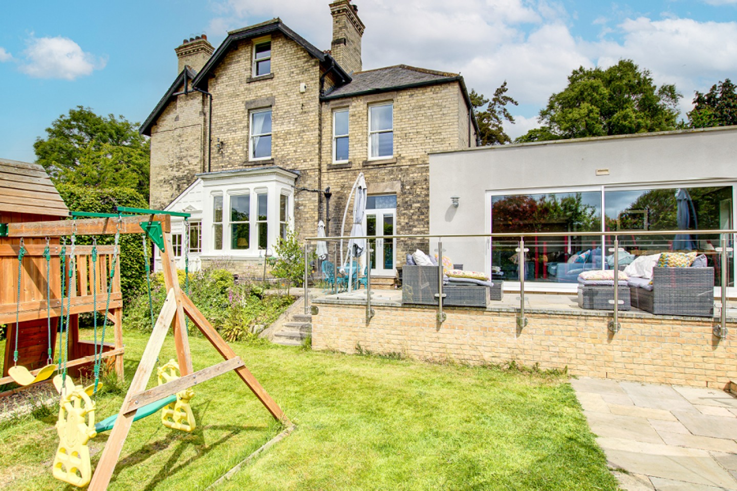 rear view of victorian house, lawned area with Childs play frame