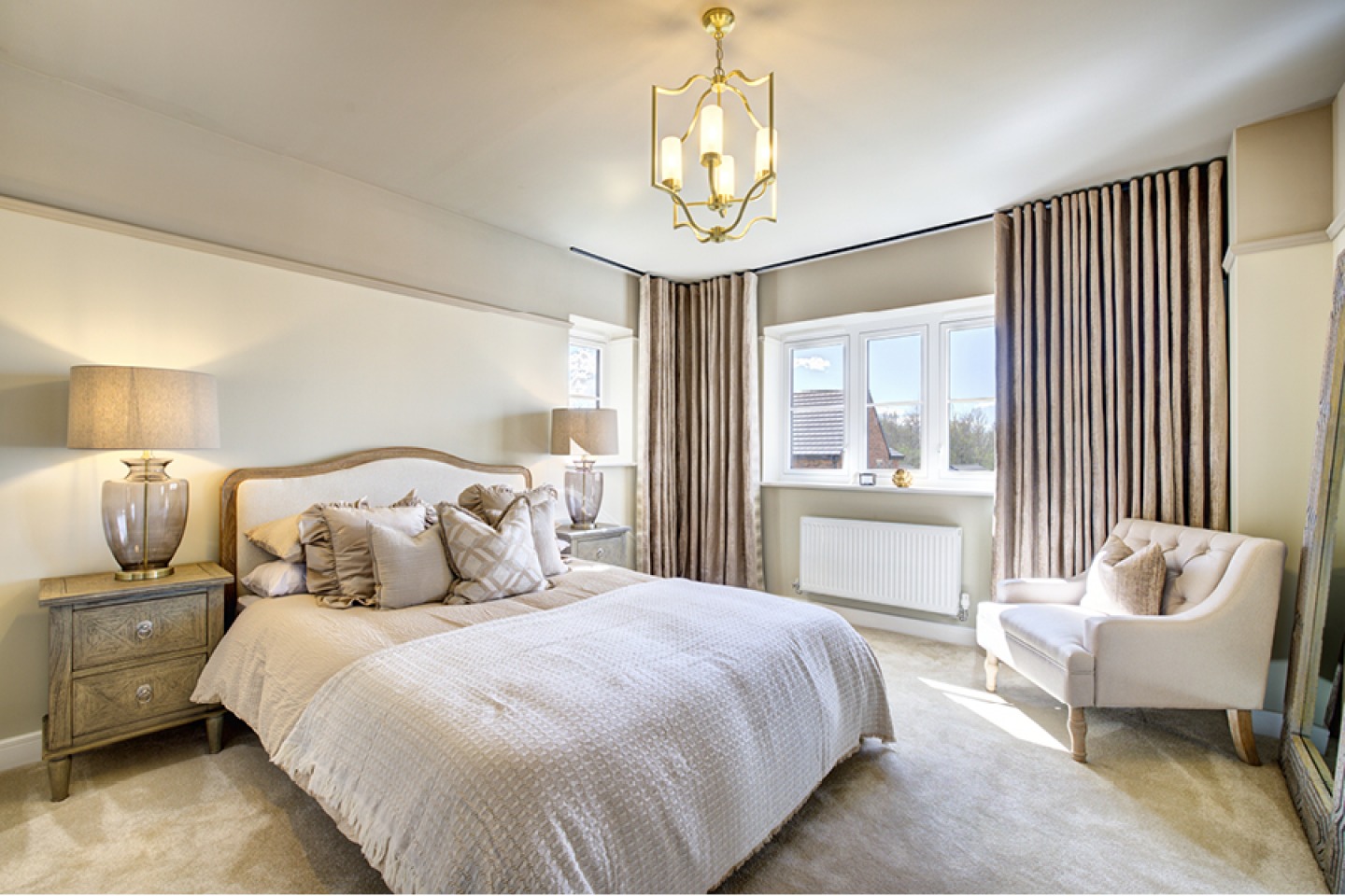 Neutral master bedroom with armchair