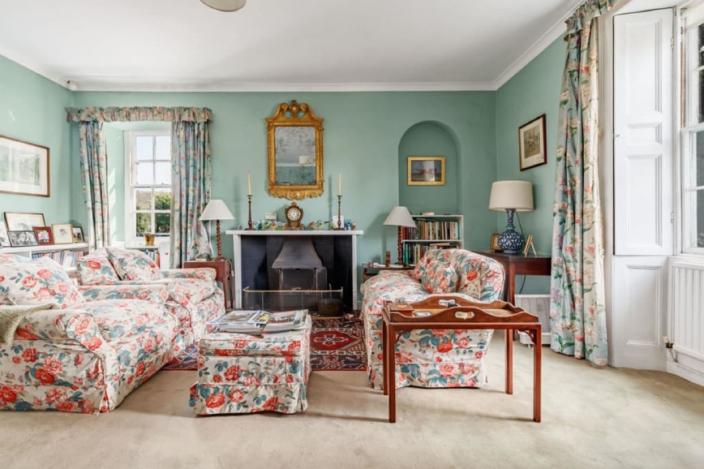 Period lounge with feature fireplace and large shuttered windows