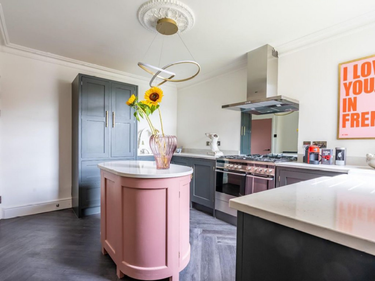 Modern shaker kitchen with oval shaped pink island