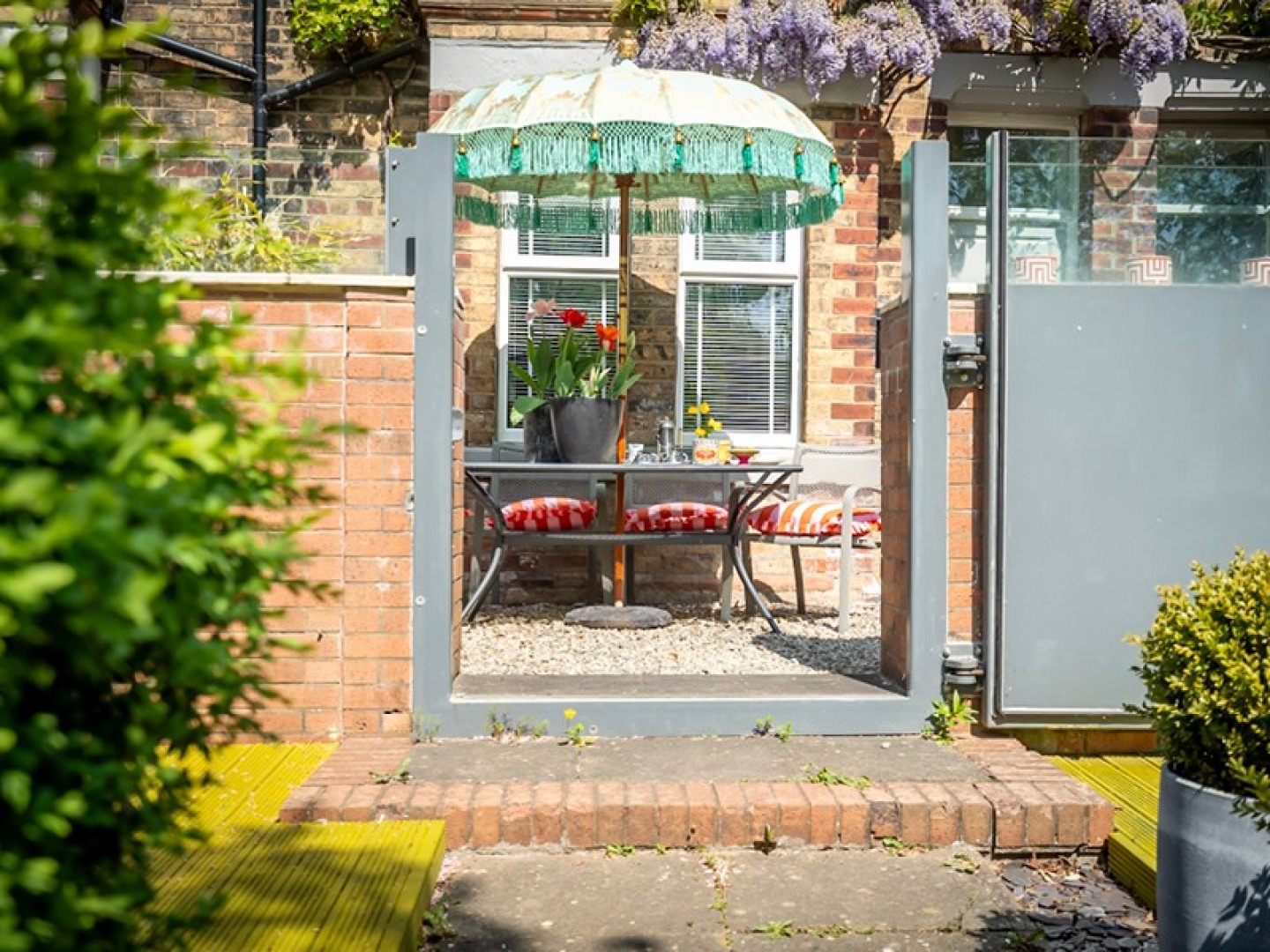 pebble courtyard with set table and umbrella