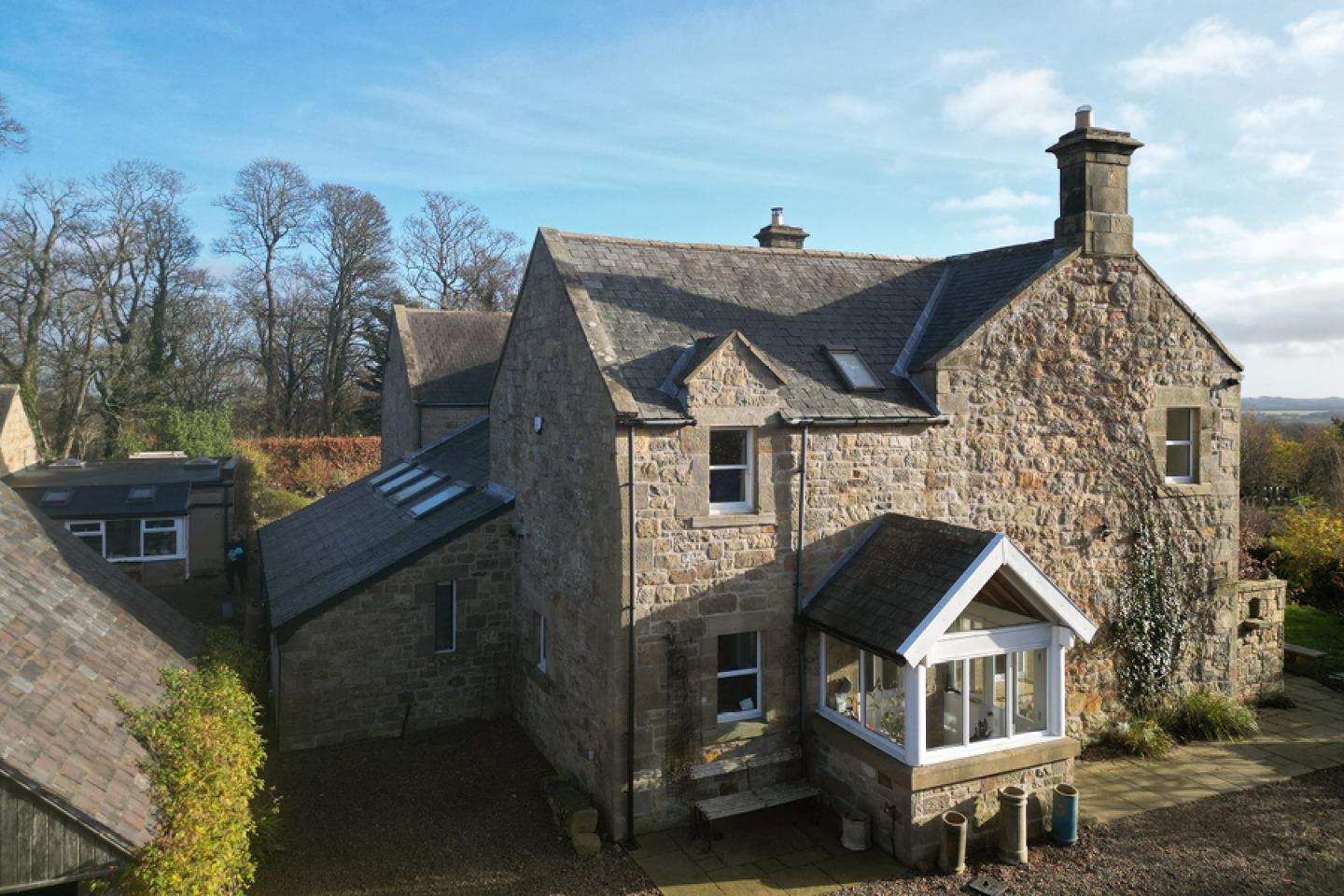 real view of a large stone built house with porch