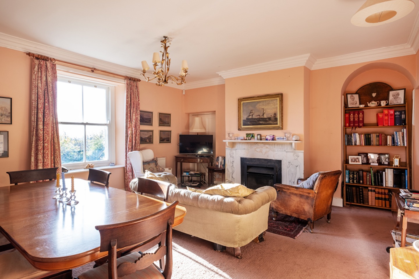 Peach coloured traditional lounge with large dining table