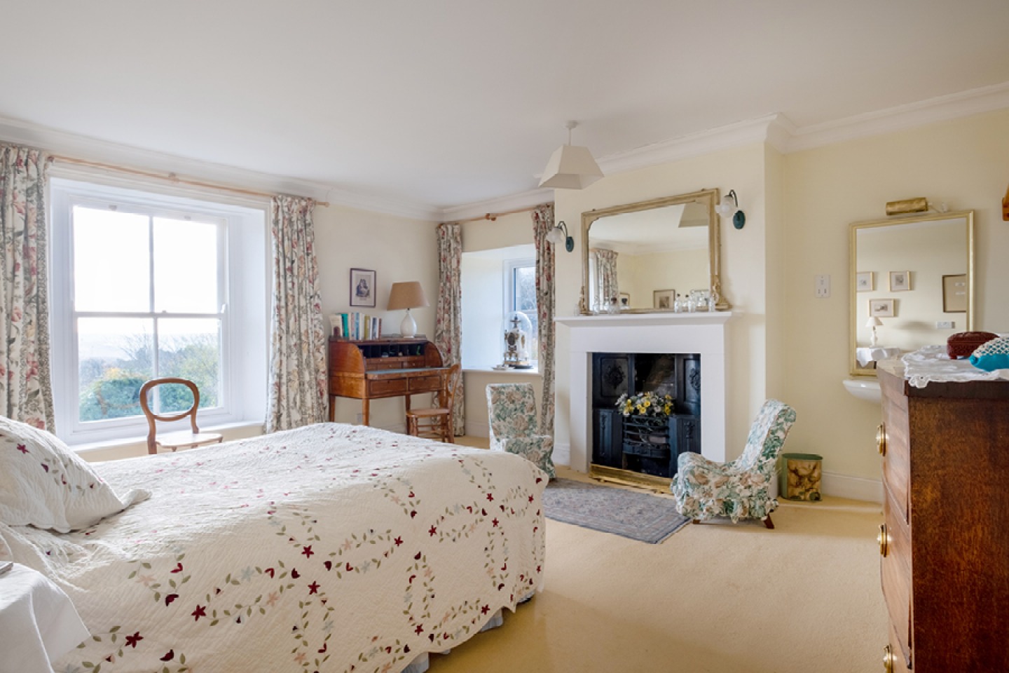 Light and airy bedroom with large window and traditional decor