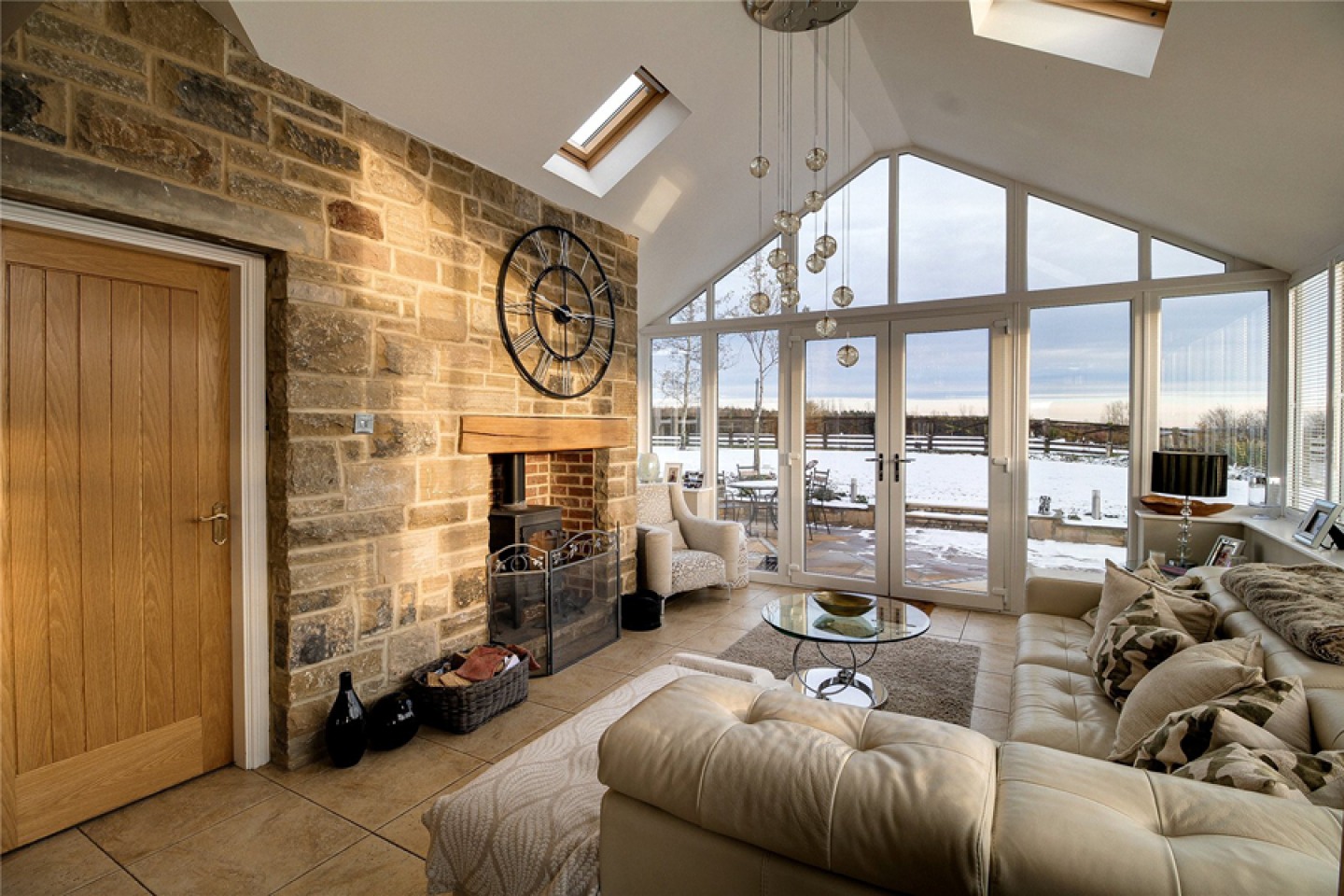 Lounge room with vaulted ceiling and full length glass doors for views over fields
