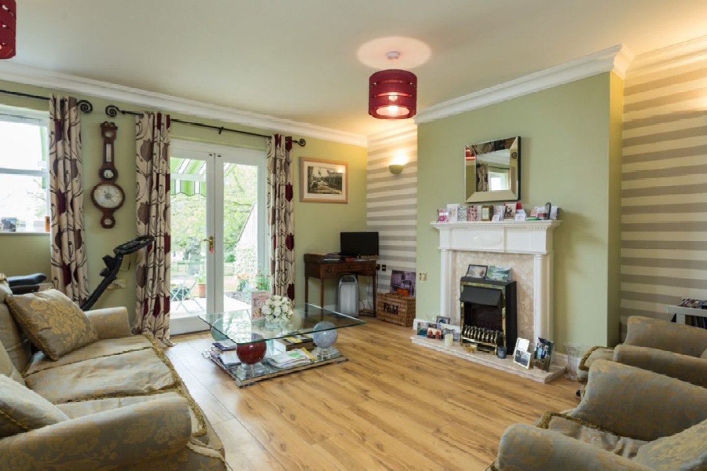 Living room with gas fire. patio door, decorated in a soft green