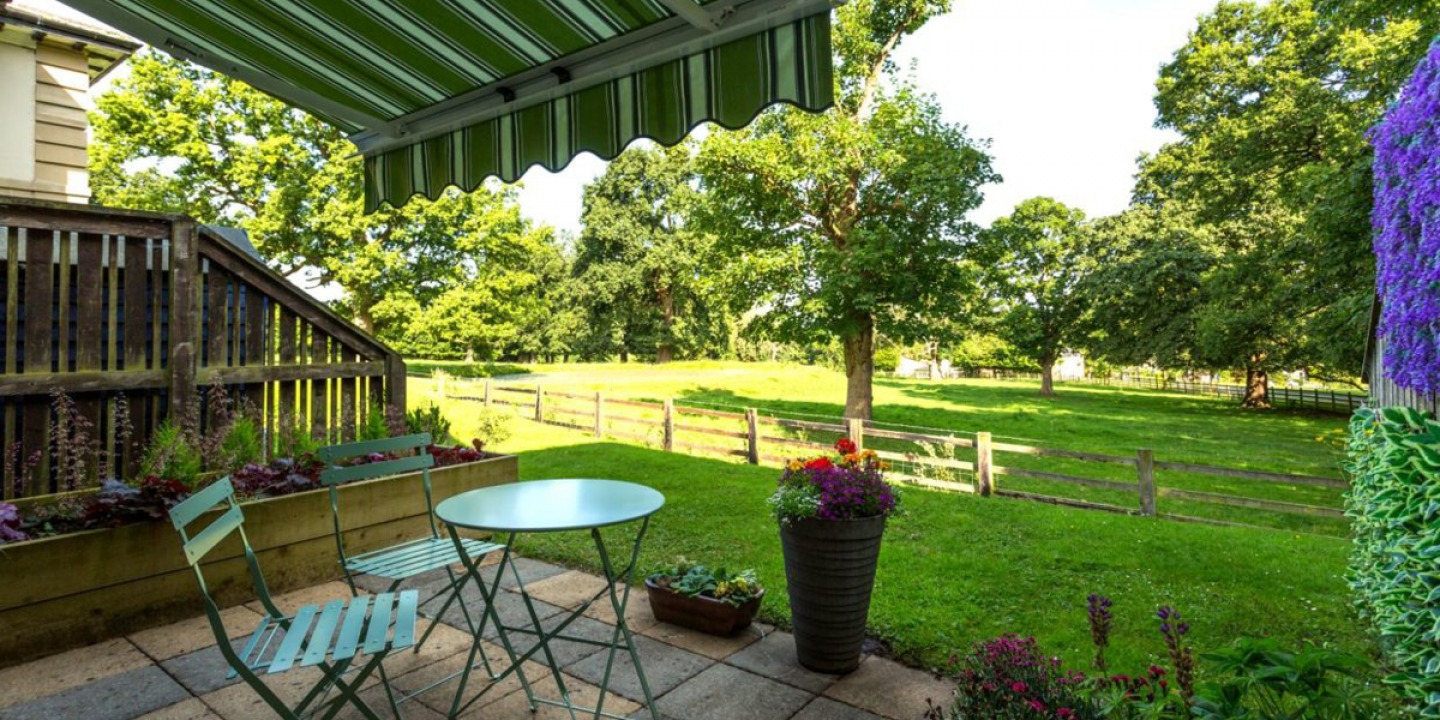 open patio area with twin chair and table set and canopy