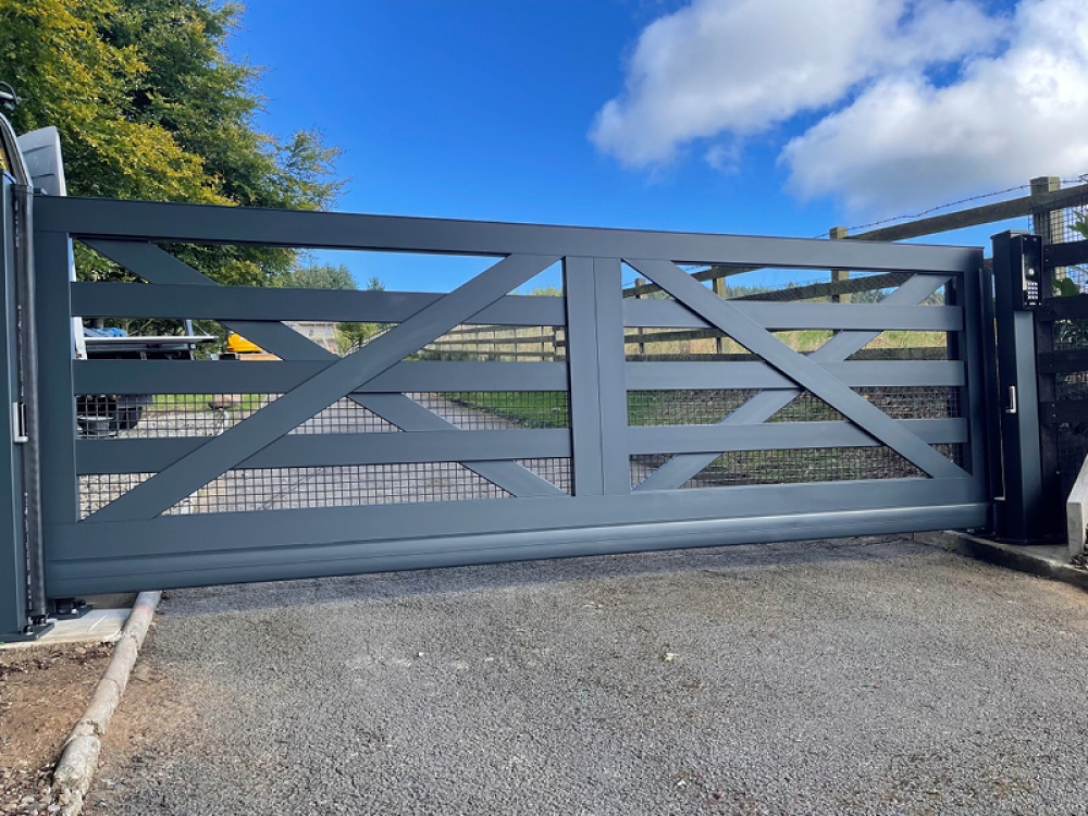 Smart black electro gate leading to a home