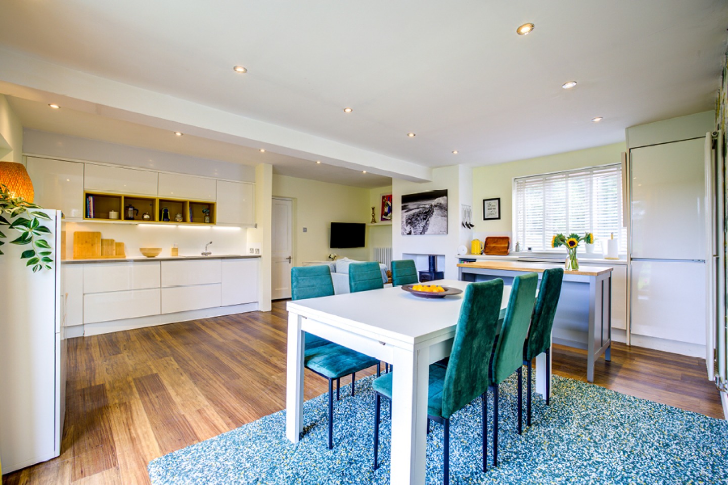 Modern high gloss white kitchen with low ceiling and down-lighters