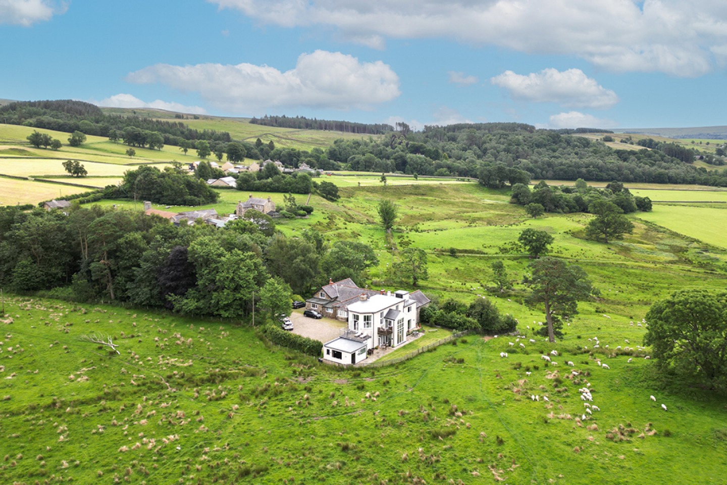 White rendered building (The Library) surrounded by farmland