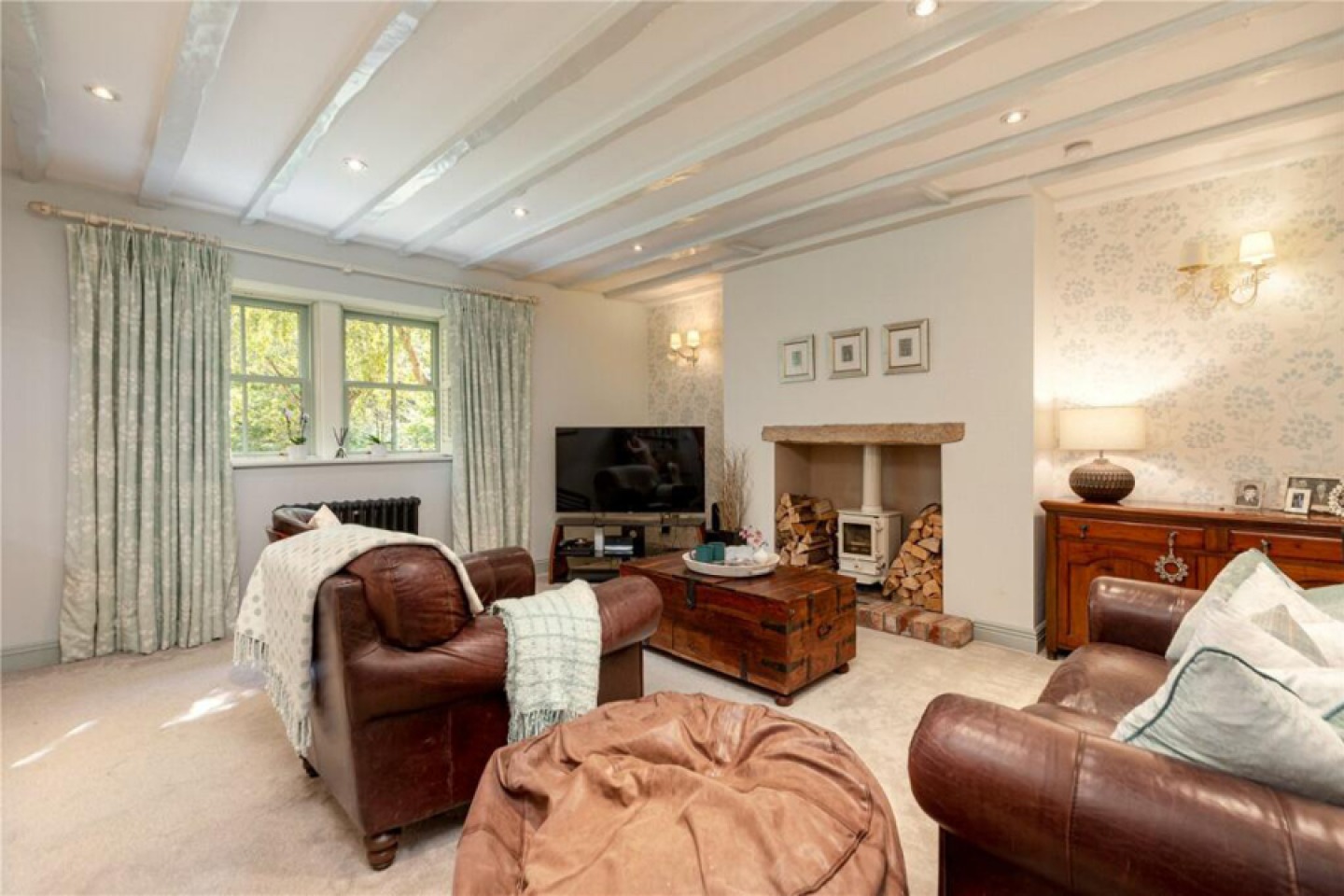 Snug living room with wood burning stove and leather sofas
