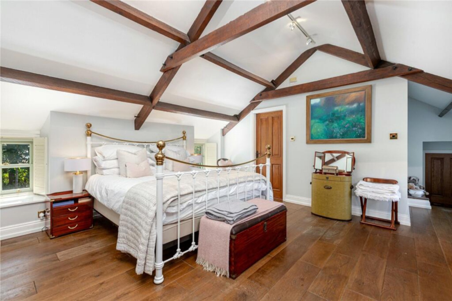 Traditional bedroom with vaulted roof and exposed beams