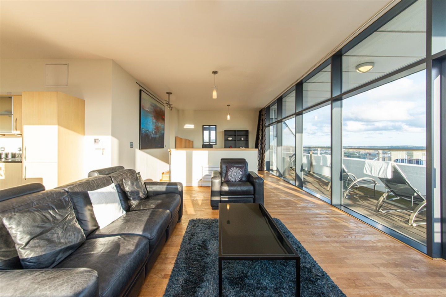Open plan living area with sliding glass doors onto a private balcony
