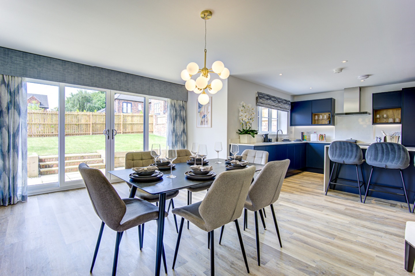 Open plan kitchen diner, modern decor in royal blue and grey
