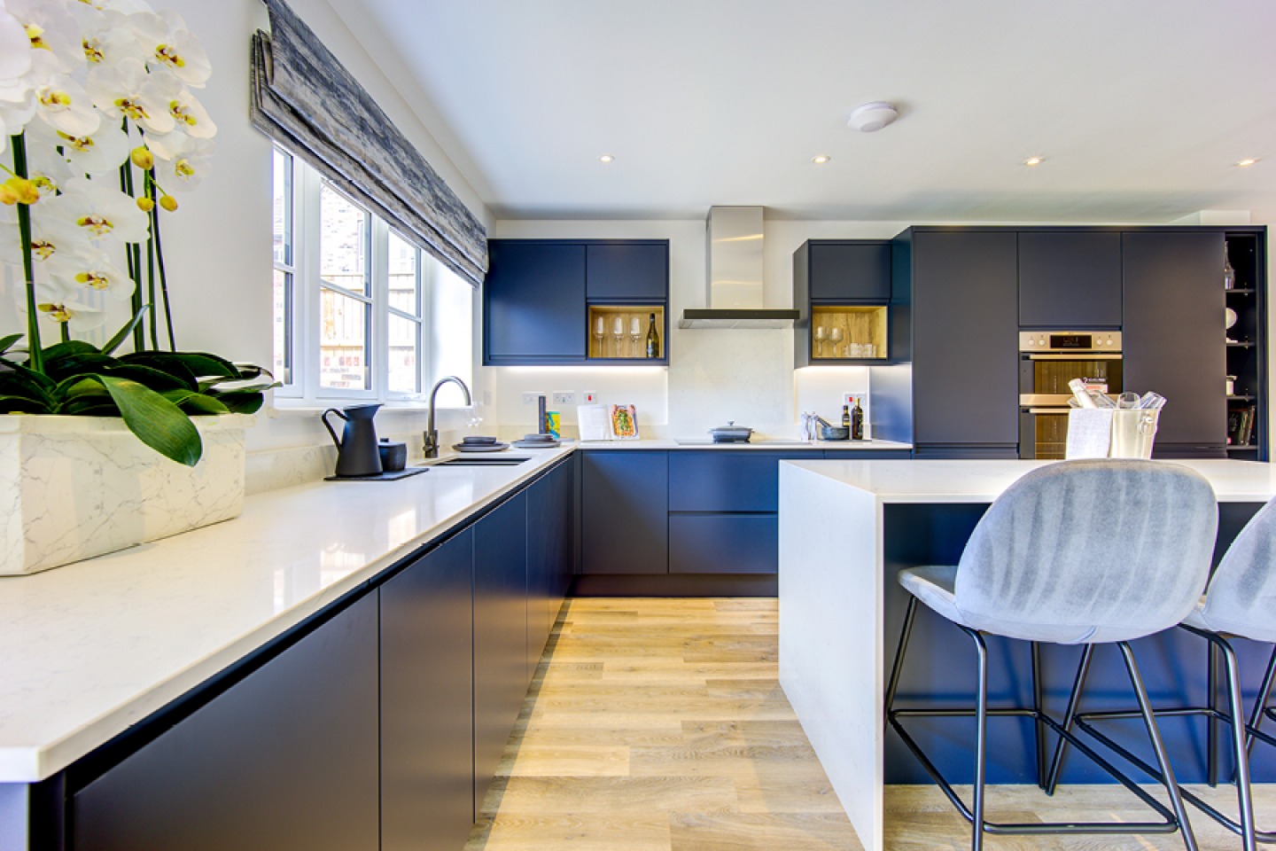 modern Royal blue handless kitchen with island and bar stools